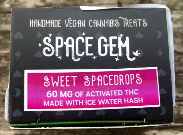 Box packaging for Space Gem Cannabis gummies. Small black and white box.