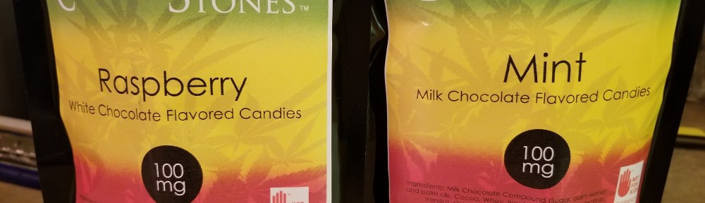 Canna Vita Botanicals Corner Stones Cannabis Infused flavored candies, two bags one of Raspberry White Chocolate flavor and one Mint Milk Chocolate flavor