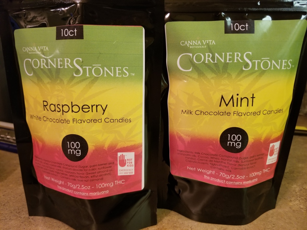 Canna Vita Botanicals Corner Stones Cannabis Infused flavored candies, two bags one of Raspberry White Chocolate flavor and one Mint Milk Chocolate flavor