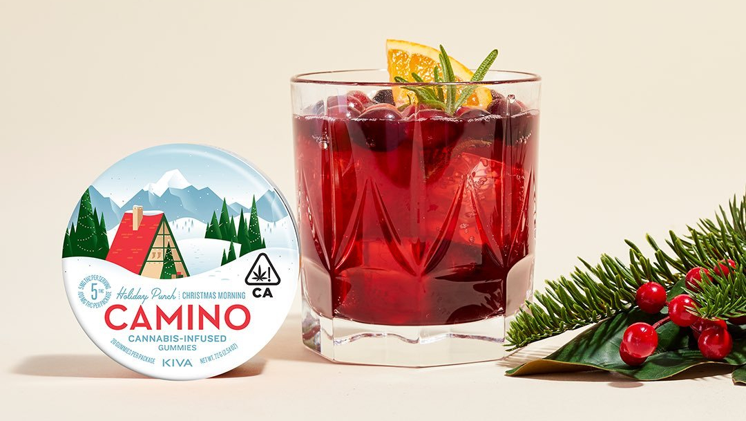 Kiva Camino Holiday Punch Cannabis Infused Gummies next to a glass of red holiday punch