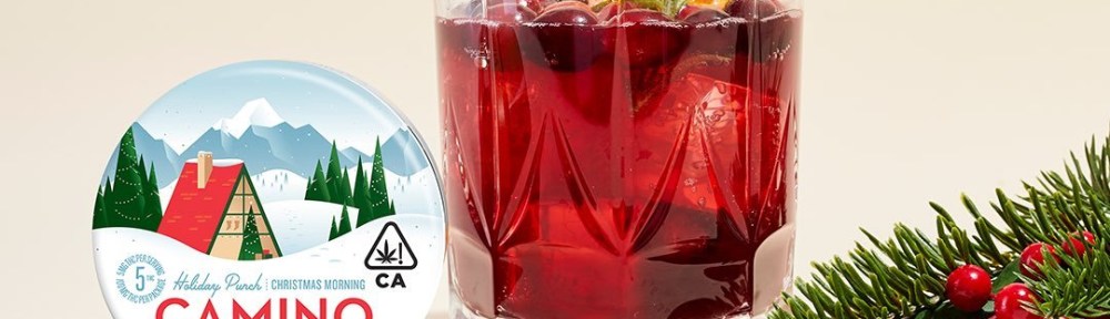 Kiva Camino Holiday Punch Cannabis Infused Gummies next to a glass of red holiday punch